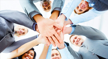 The image of professionals standing in a circle holding hands together illustrates the strong linkage to investors.